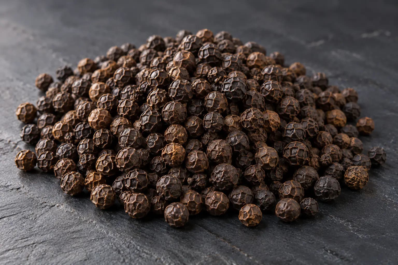 Heap of whole black peppercorns from Kerala